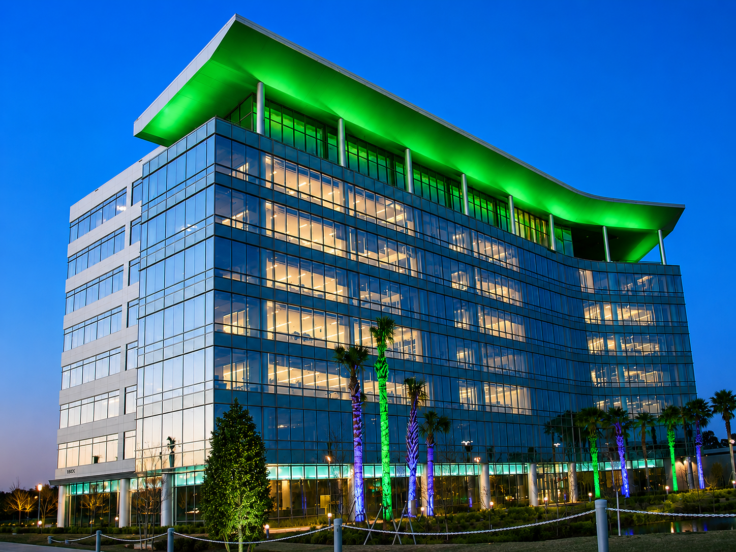 Modern office building illuminated with architectural accent lighting at dusk